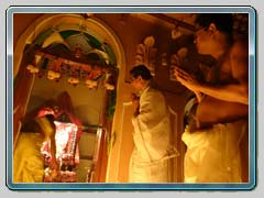 Family members praying with devotion at Baghbazar Haldarbari